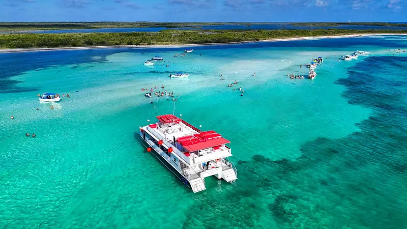 VIP sailing catamaran anchored over the shallow El Cielo sandbar near Cozumel on a Playa del Carmen boat tour, Mexico